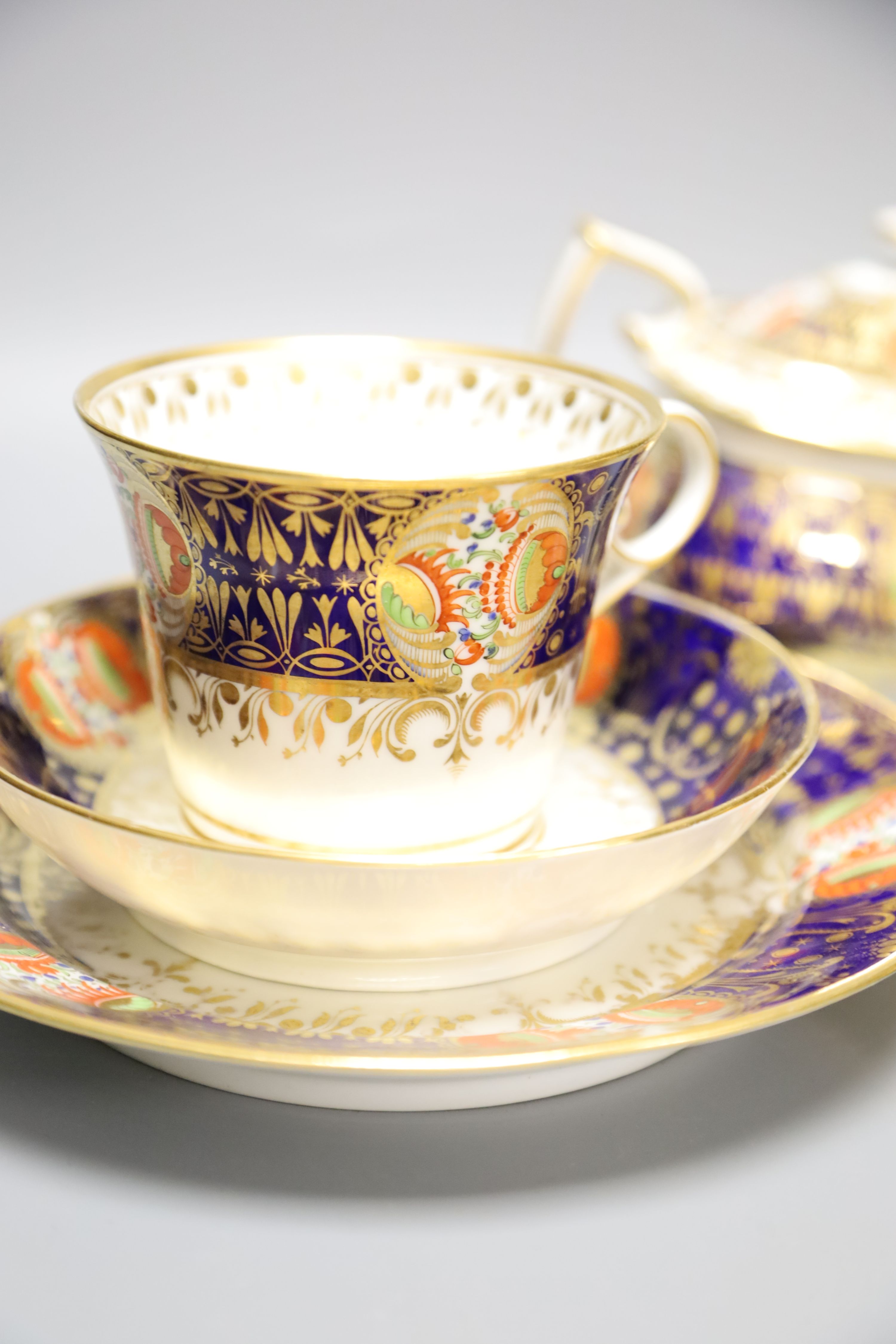 An early 19th century Chamberlains Worcester imari-style graduated set of three cups and saucers, a plate and a sucrier and